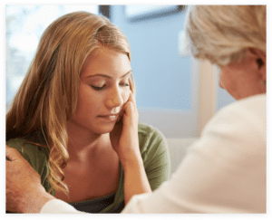 woman comforting a distressed young woman